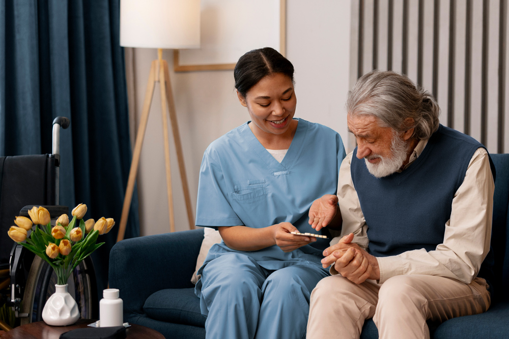 Healthcare worker in scrubs assisting elderly man with medication at home